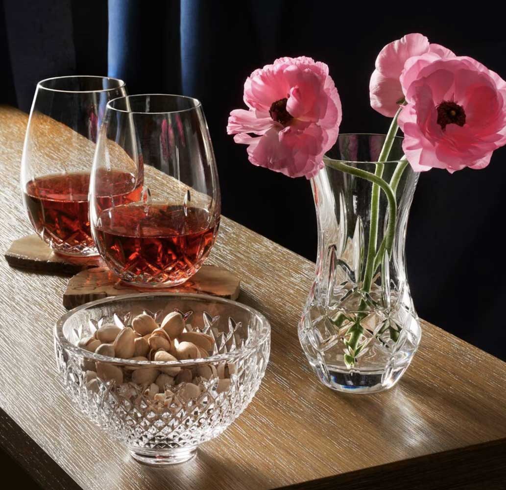 Waterford Lismore vase with flowers, stemless wine glasses and a nut bowl