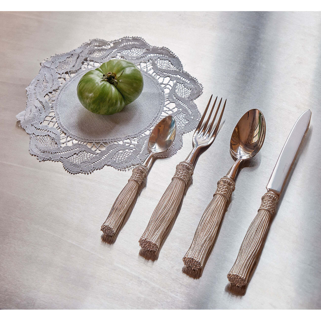 Christofle Pompon 4-piece Silver-plated Individual Place Settings in silver-plate on a white background