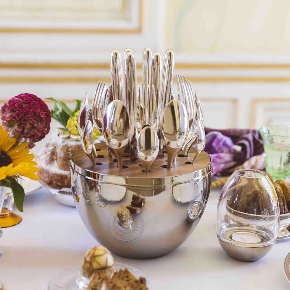 Christofle Mood silver-plated egg-shaped flatware case with 6 table knives, 6 table forks, 6 table spoons, and 6 teaspoons set on a table