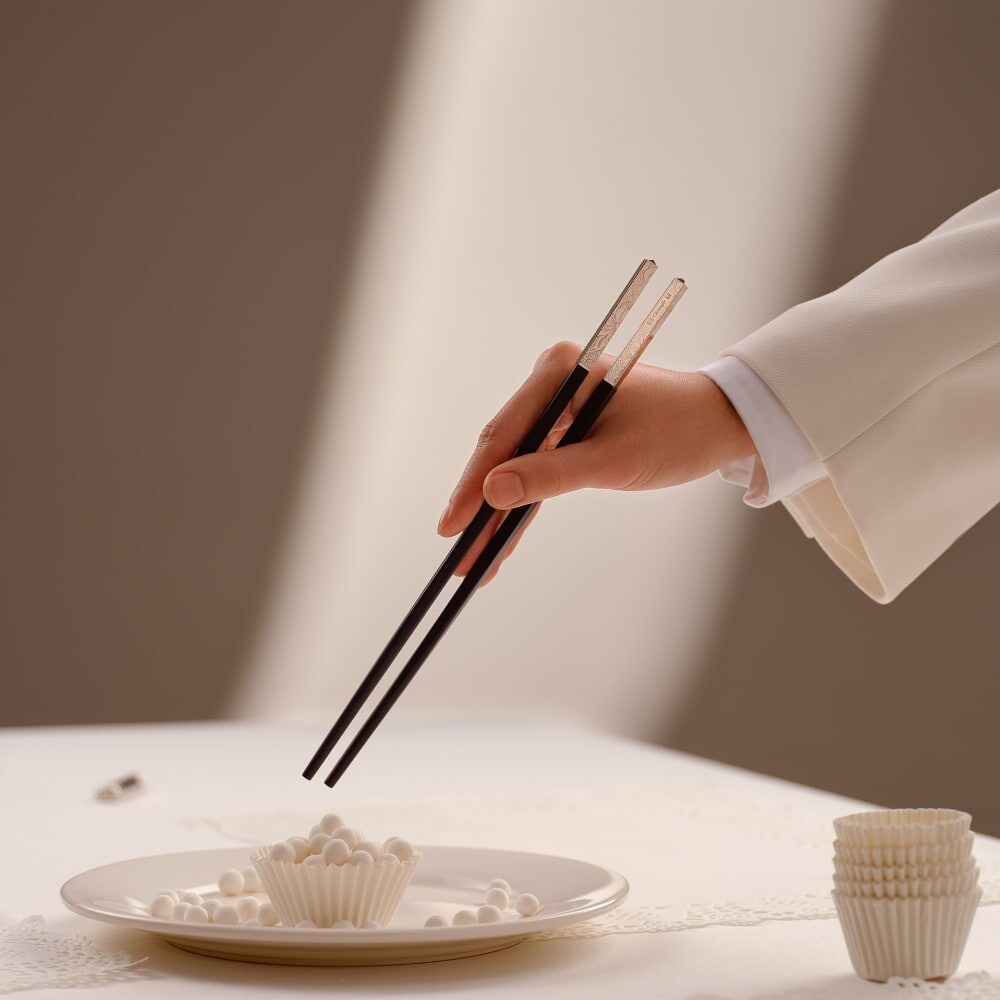 Christofle Jardin d'Eden Rose Gold Japanese Chopsticks on a white background