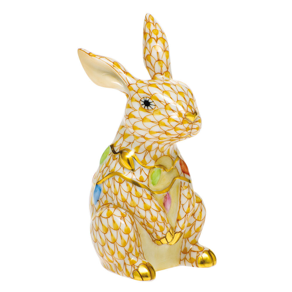 Hand-painted Herend Bunny with Christmas Lights Figurine in Butterscotch fishnet porcelain on a white background