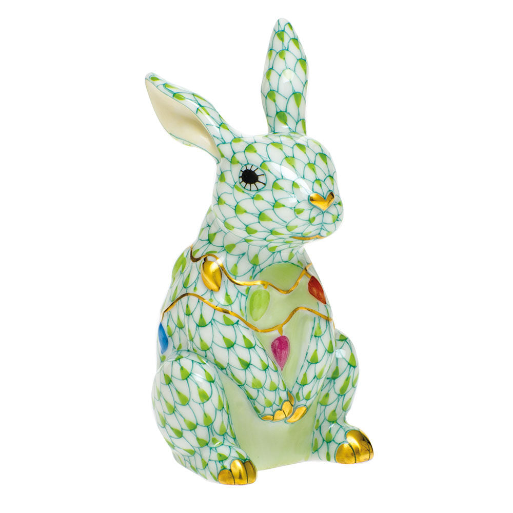 Hand-painted Herend Bunny with Christmas Lights Figurine in Key Lime fishnet porcelain on a white background