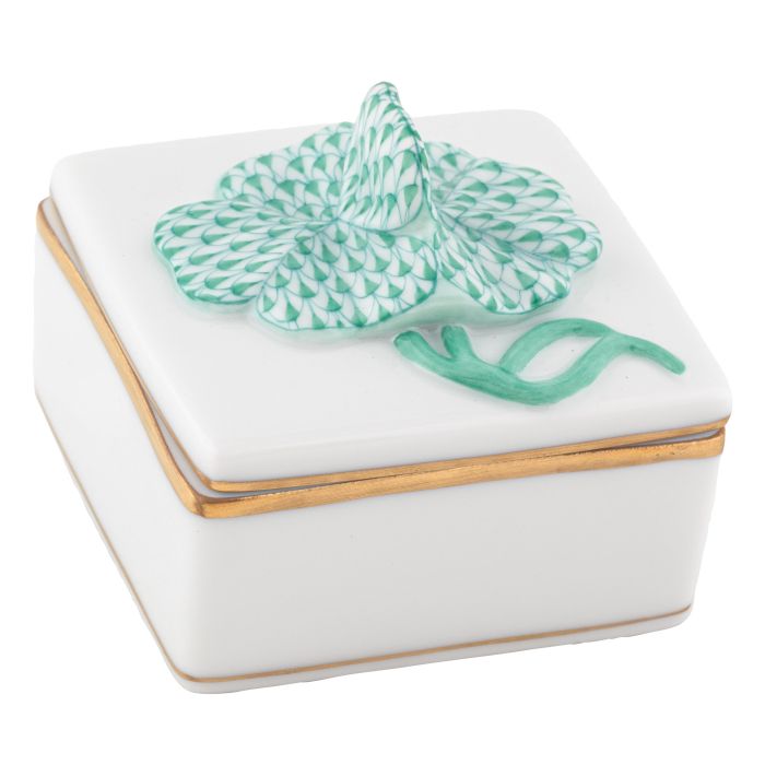 Decorative box with green four-leaf clover on top, gilded sides
