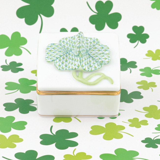 Decorative clover box with gilded sides surrounded by green and keylime clovers