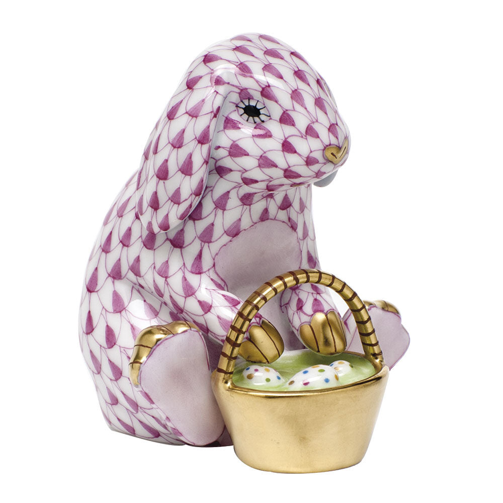 Hand-painted Herend Eggstravagant Rabbit Figurine in Raspberry fishnet porcelain on a white background