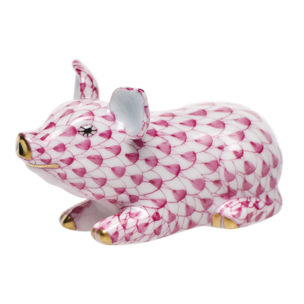 Hand-painted Herend Little Pig Lying Figurine in Raspberry fishnet porcelain on a white background