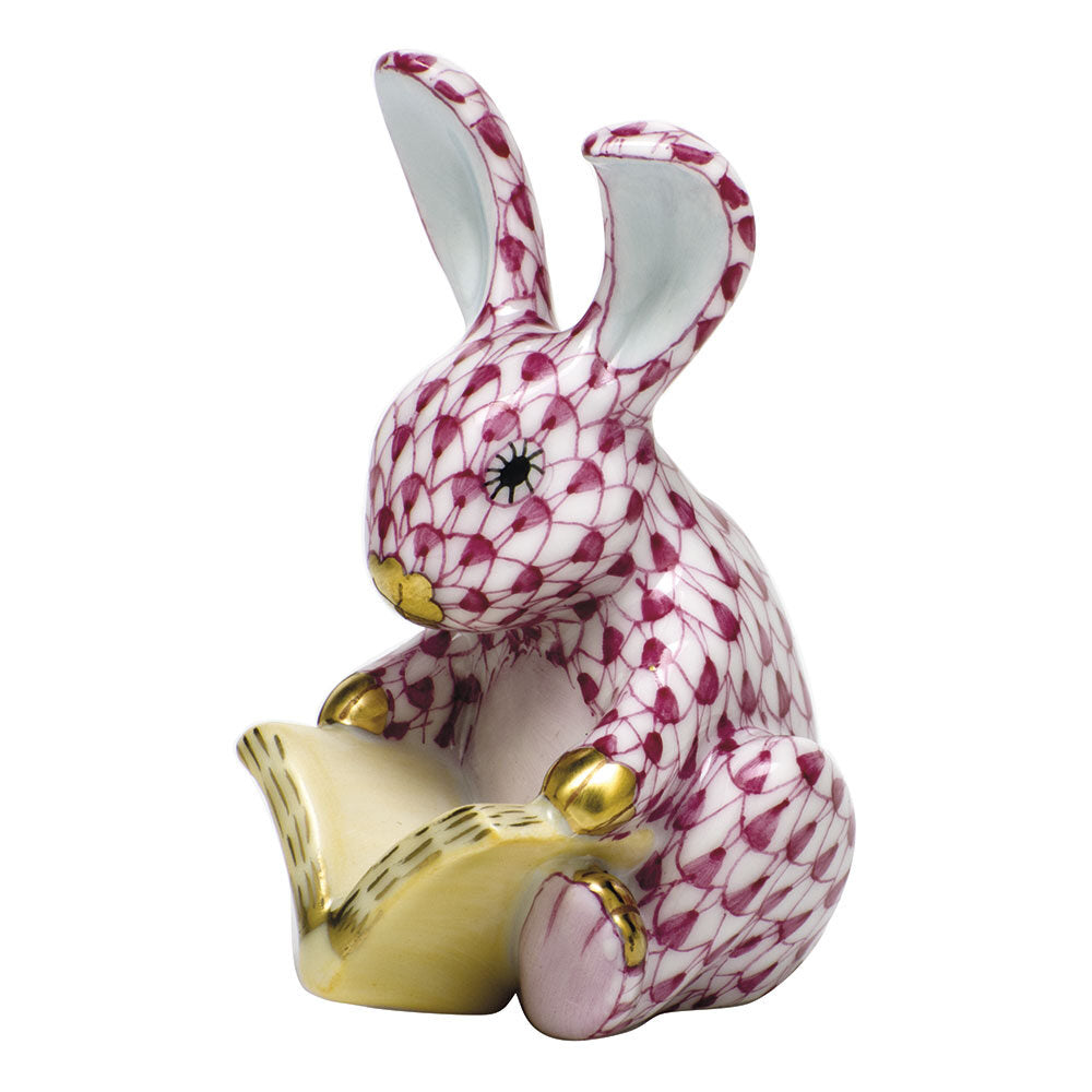 Hand-painted Herend Storybook Bunny Figurine in Raspberry fishnet porcelain on a white background