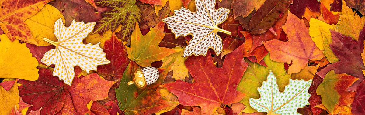 Herend maple leaf figurines and a gold acorn in fishnet porcelain on autumn leaves