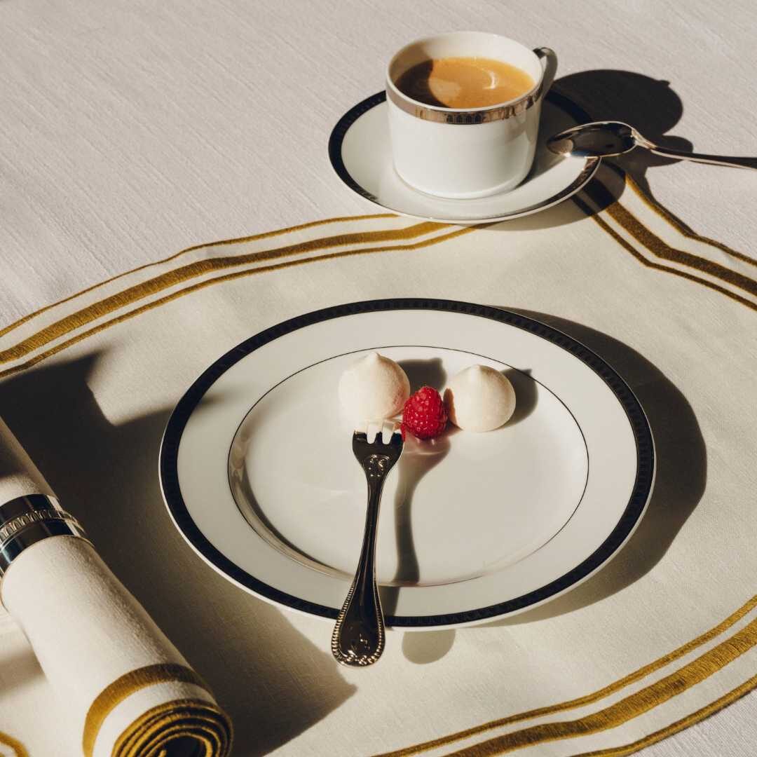 Christofle Malmaison Gilded Porcelain Teacup and Saucer in porcelain on a white background