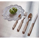 Christofle Pompon 4-piece Silver-plated Individual Place Settings in silver-plate on a white background