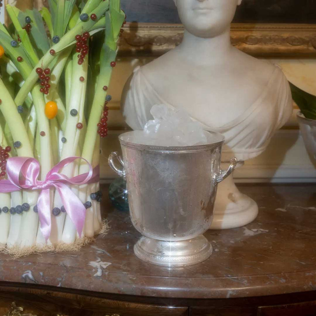 christofle malmaison silver-plated ice bucket with pedestal and handles on two sides filled with ice