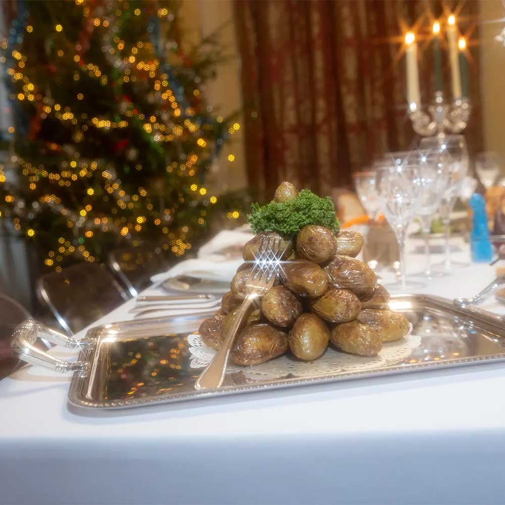 christofle malmaison silver-plated rectangular tray with handles on two ends, with roasted potatoes served in it