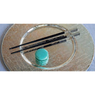 Christofle Black Japanese Chopsticks in silver-plate on a white background