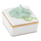 Decorative box with a keylime four-leaf clover on top, gilded sides