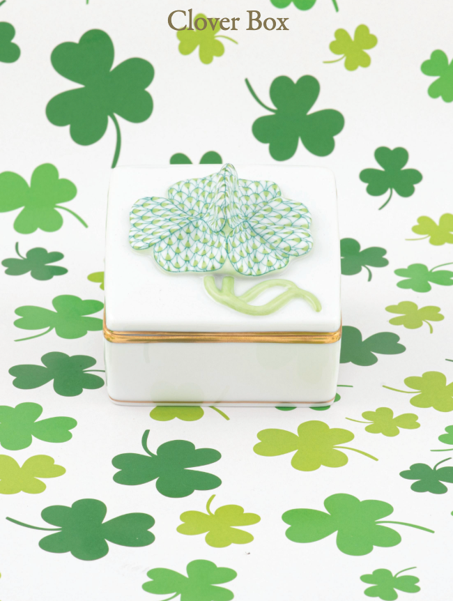 Decorative clover box with gilded sides surrounded by green and keylime clovers