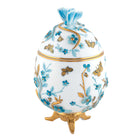 Hand-painted Herend Egg with Flowers- Blue Decorative Box in fine porcelain, 3.75in L X 3.5in W X 6in H, on a white background