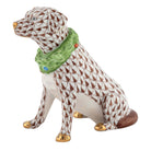 Hand-painted Herend Holiday Dog Figurine in Chocolate fishnet porcelain on a white background