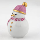 Snowman figurine with a pink hat and scarf on a white background