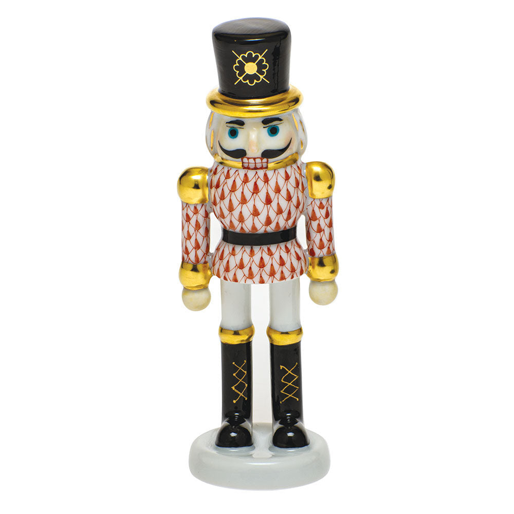 Hand-painted Herend Nutcracker Figurine in Rust fishnet porcelain on a white background