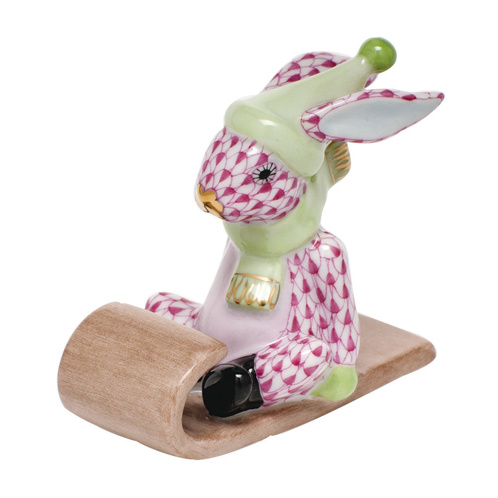 Herend Sledding Bunny Figurine porcelain figurine painted in the Raspberry fishnet pattern