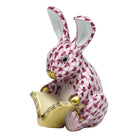 Hand-painted Herend Storybook Bunny Figurine in Raspberry fishnet porcelain on a white background